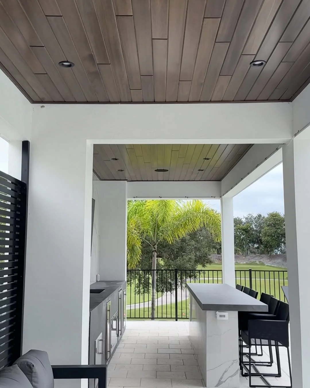 Red Grandis Ebony ceiling over a covered patio with an outdoor dining counter