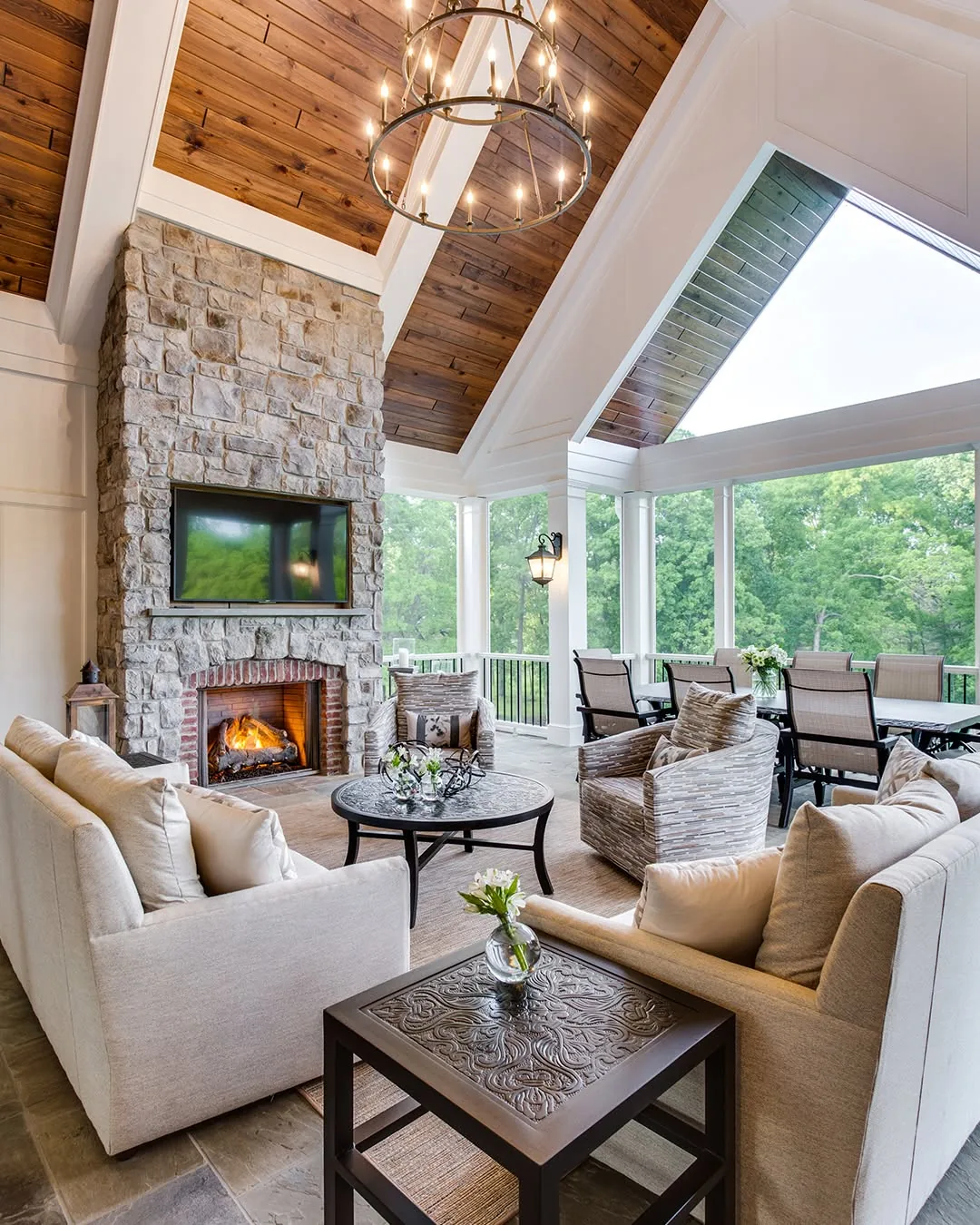Vaulted Southern Pine ceiling with white beams above a stone fireplace and seating area