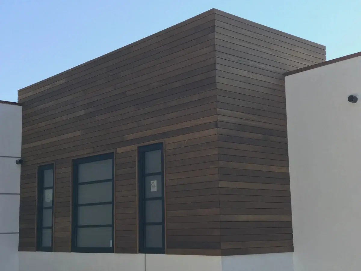 Thermally modified Ash siding wrapping a modern exterior