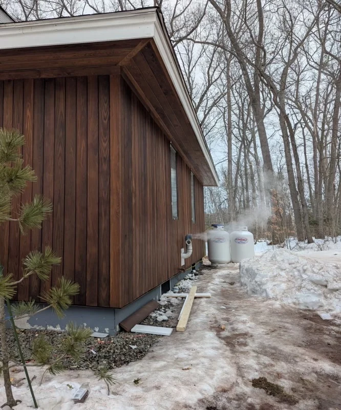Thermally modified Ash siding installed vertically on a winter residence